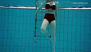 I admire Dashka's beautiful big tits in the pool