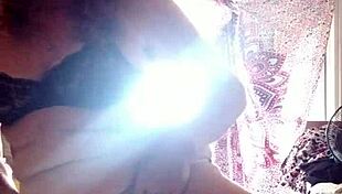 Mature Woman Applies Lotion to Her Sexy Skin in Nude Setting