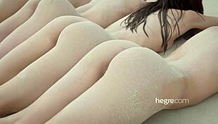 Four beautiful girls strip naked on the beach