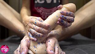 Beautiful woman gives a sensual footjob to a man with a rubber cock - foot fetish