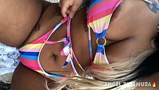 Angel Takemura poses topless for surfers at Grumari beach.