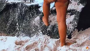 Angel Takemura poses topless for surfers at Grumari beach.