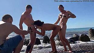 Four homeless guys bang a student hard on the beach