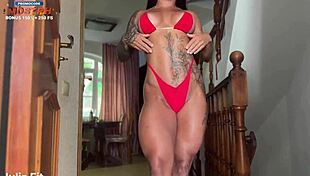 A beautiful athletic woman with a Brunette hair wears a red bikini and gets covered in white sauce