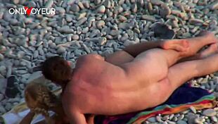 Beach voyeur watches blonde couple on public sand