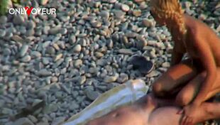 Beach voyeur watches blonde couple on public sand
