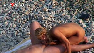 Beach voyeur watches blonde couple on public sand