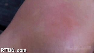 Stripping inside a petite metallic cage with ripped clothes.