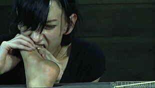 Stripping inside a petite metallic cage with ripped clothes.