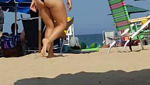 Check out this candid shot of the little slut's ass in bikini at the beach.