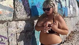 milf with wet big boobs sucks on a toy during outdoor public massage session