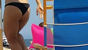Check out this candid shot of the little slut's ass in bikini at the beach.