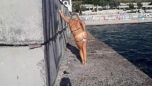 milf with wet big boobs sucks on a toy during outdoor public massage session