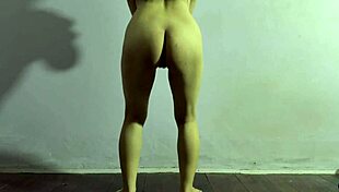 An appetizing girl is doing exercises at home to keep fit