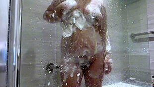 Indian MILF with big tits bathes and fingers her cunt