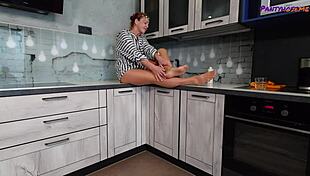 mature redhead iris shows legs and feet in tan pantyhose.