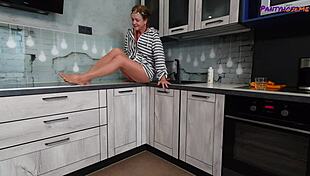 mature redhead iris shows legs and feet in tan pantyhose.