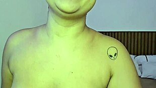 Pornstar performs solo striptease in bedroom.