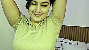 Pornstar performs solo striptease in bedroom.