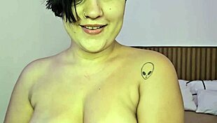 Pornstar performs solo striptease in bedroom.