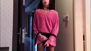 Asian ladyboy masturbates her dick, flashes it to woman, and cums.