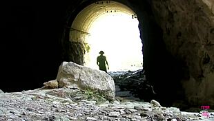 Hot brunette chained to rock gets intensely fucked by clown outdoors.