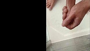 A muscular blonde bodybuilder with blue eyes showers her cock in the bath