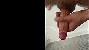 A muscular blonde bodybuilder with blue eyes showers her cock in the bath