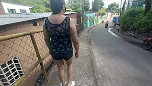 Latina Woman in Shorts Walking on the Street with Stepson