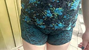 Latina Woman in Shorts Walking on the Street with Stepson