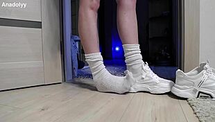 Delicate legs in sneakers wait patiently in the british shower.