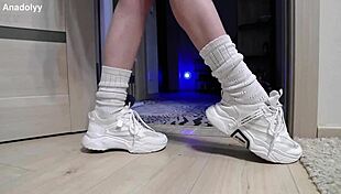 Delicate legs in sneakers wait patiently in the british shower.