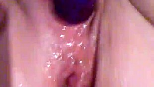 Slow motion close-up of wife plunging toy into dripping squirting pussy