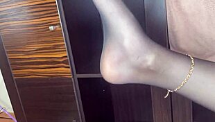 Closeup Foot In Black Stockings Plays With Anal Beads