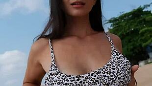 Petite girl waits on the beach in summer bikini