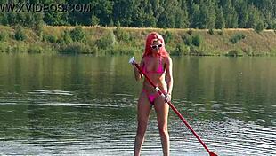 Tall skinny girl flashes her small tits in pink micro bikini at the beach