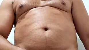 Brazilian bear Yuri Gaucho gives amateur handjob to huge black cock with big cumload