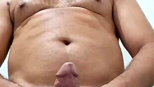 Brazilian bear Yuri Gaucho gives amateur handjob to huge black cock with big cumload