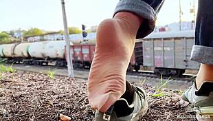Tan nylon soles in blue jeans teasing on the bench