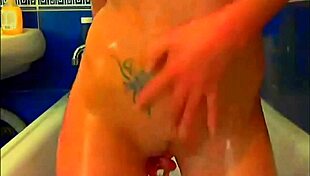 tattooed model plays with glass dildo in webcam solo masturbation