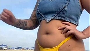 African woman flashes on beach.