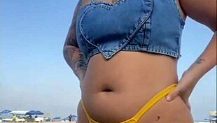 African woman flashes on beach.