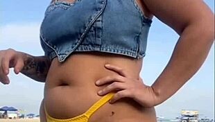 African woman flashes on beach.