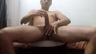 Guy massaging his big muscles in relaxing home session.