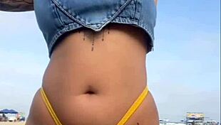 African woman flashes on beach.