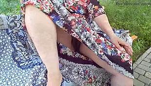 hairy mature woman flashes her chubby body in a see-through dress outdoors