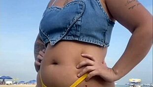 African woman flashes on beach.