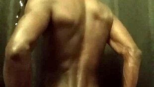 Have you seen this muscular bodybuilder stroking his big black cock with oil?