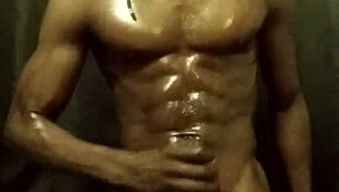 Have you seen this muscular bodybuilder stroking his big black cock with oil?