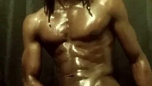 Have you seen this muscular bodybuilder stroking his big black cock with oil?
